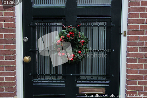 Image of Traditional Christmas wreath on a glass door