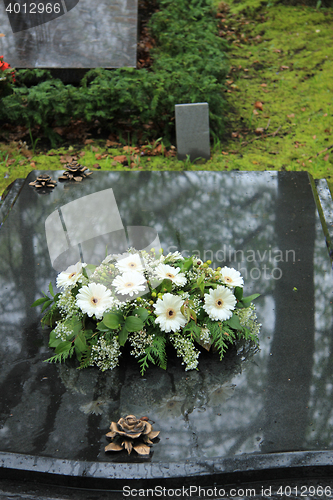Image of Funeral flowers on a tomb