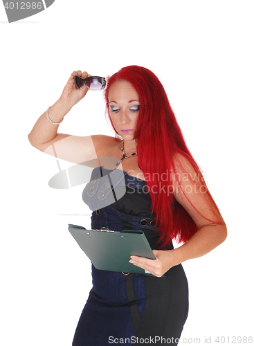 Image of Woman with clipboard and glasses.