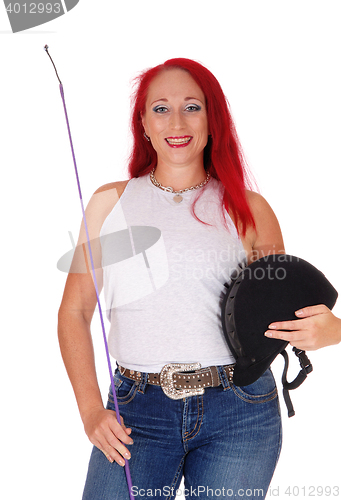 Image of A horseback rider woman with helmet.			