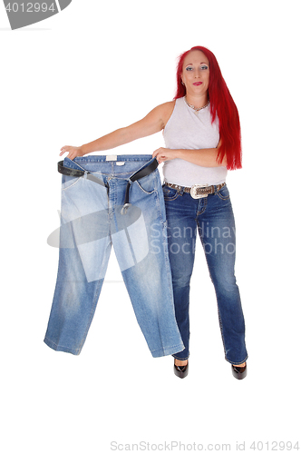 Image of Woman holding big pants.