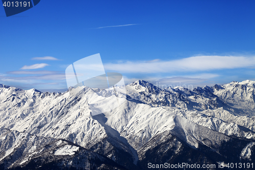 Image of Snowy mountains and blue sky with clouds in nice sunny day