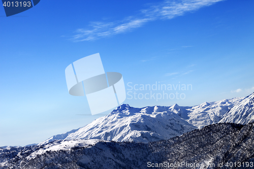 Image of Snowy mountains and blue sky in early sunny morning