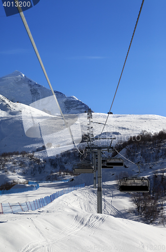 Image of Chair-lift at ski resort in sun winter morning