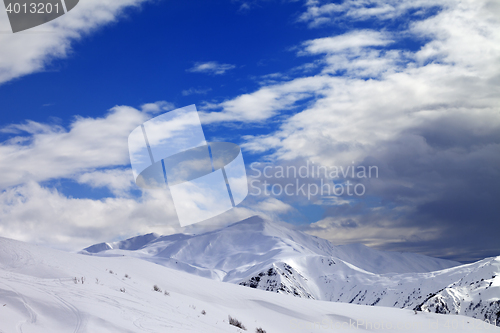 Image of Ski slope and beautiful sky with clouds in evening