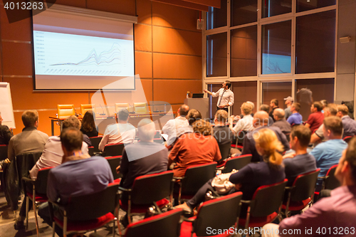 Image of Business speaker giving a talk in conference hall.