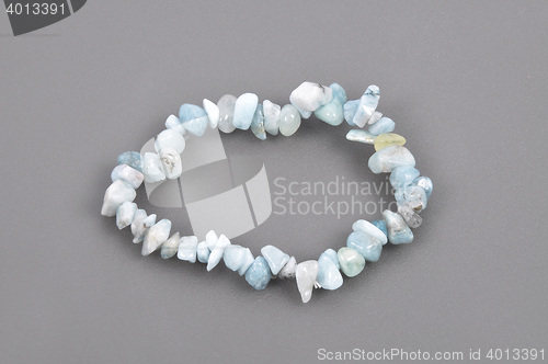 Image of Splintered aquamarine chain on gray background