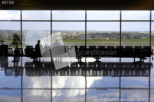 Image of Two passengers waiting in airport lounge