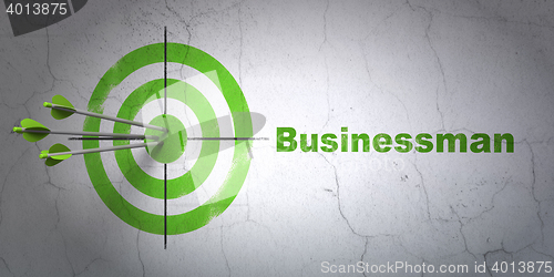 Image of Business concept: target and Businessman on wall background