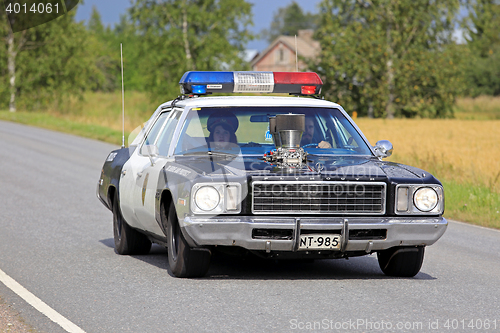 Image of Customized Plymouth Police Car on the Road