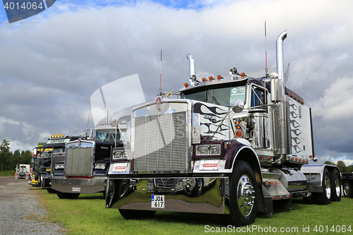 Image of Classic Kenworth Show Trucks under Dramatic Sky