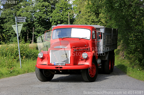Image of Classic Red Volvo N86 Truck Enters Highway
