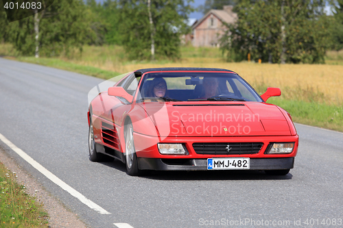 Image of Red Ferrari 348 Cruising Along Country Road