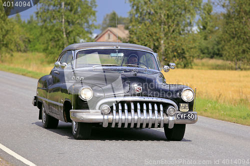 Image of Black Buick Super Eight Classic Car Cruising Along Rural Road