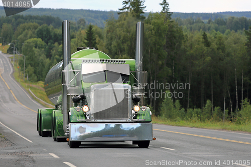 Image of Green Peterbilt 359 Tank Truck on Scenic Highway