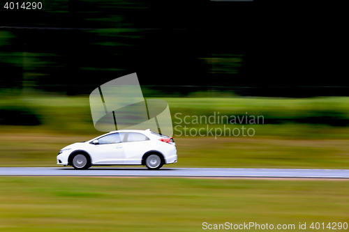 Image of Fast White Car on Freeway