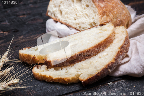 Image of Rustic bread on wood table. Dark moody background with free text space.