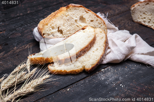 Image of Rustic bread on wood table. Dark moody background with free text space.