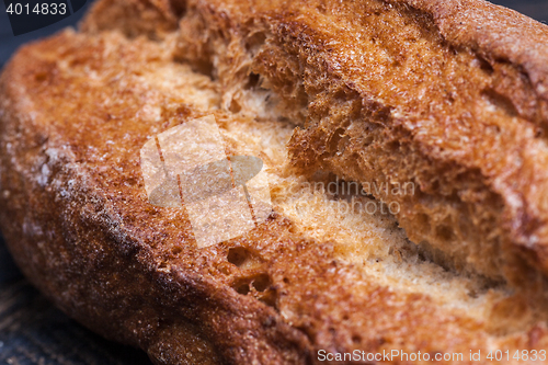 Image of Rustic bread on wood table. Dark moody background with free text space.