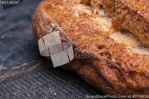 Image of Rustic bread on wood table. Dark moody background with free text space.