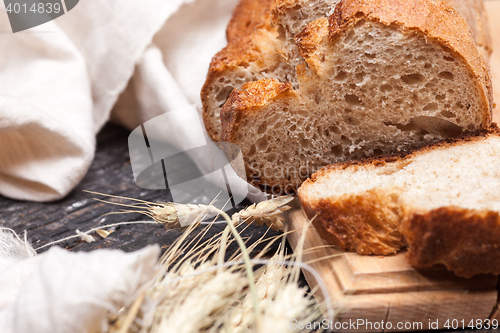 Image of Rustic bread on wood table. Dark wooden background