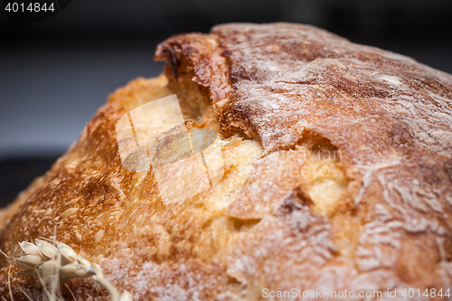 Image of Rustic bread on wood table. Dark wooden background