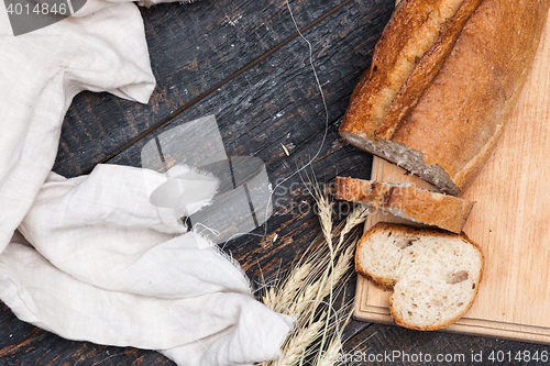 Image of Rustic bread on wood table. Dark woody background with free text space.