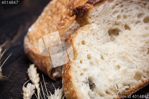 Image of Rustic bread on wood table. Dark wooden background