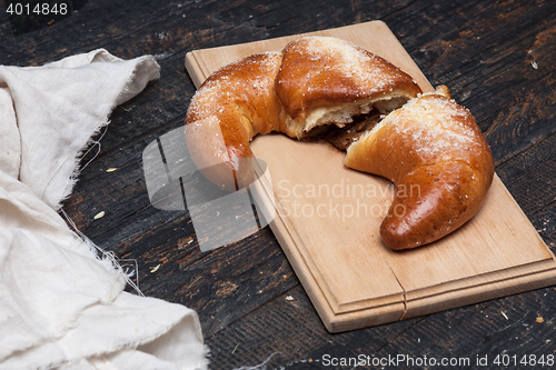 Image of Tasty croissant on wooden background