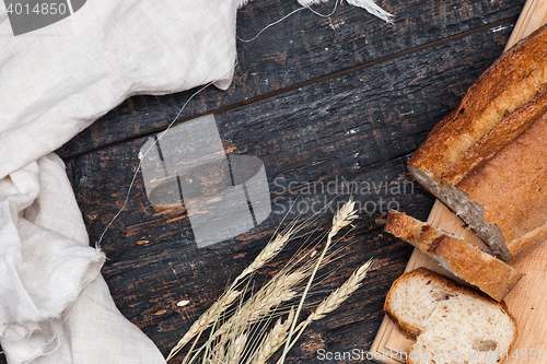 Image of Rustic bread on wood table. Dark woody background with free text space.