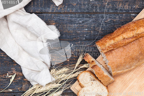 Image of Rustic bread on wood table. Dark woody background with free text space.