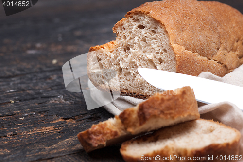 Image of Rustic bread on wood table. Dark woody background with free text space.