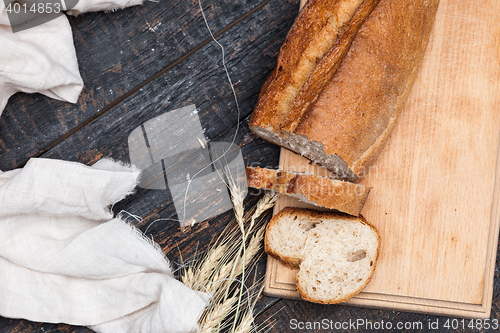 Image of Rustic bread on wood table. Dark woody background with free text space.