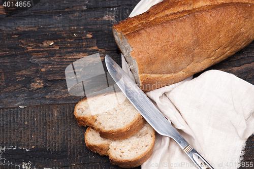 Image of Rustic bread on wood table. Dark woody background with free text space.