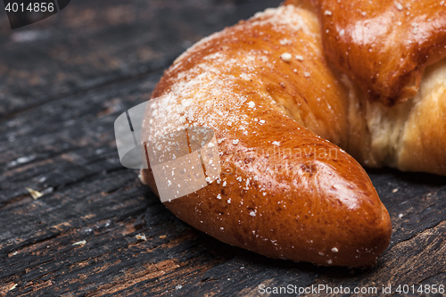 Image of Tasty croissant on wooden background
