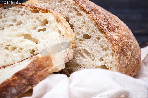 Image of Rustic bread on wood table. Dark wooden background