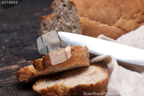 Image of Rustic bread on wood table. Dark woody background with free text space.