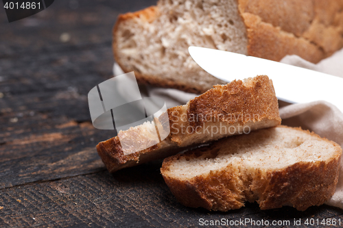 Image of Rustic bread on wood table. Dark woody background with free text space.