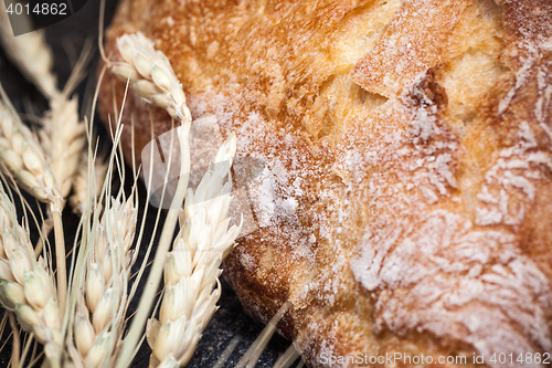 Image of Rustic bread on wood table. Dark wooden background