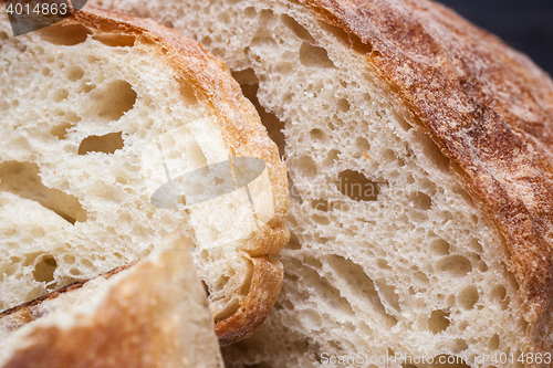 Image of Rustic bread on wood table. Dark wooden background