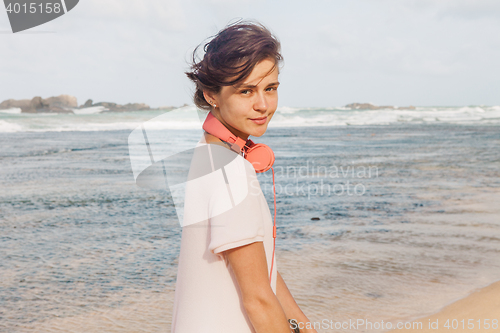 Image of Woman walking on the beach