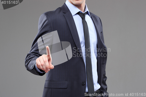 Image of Business Man pushing on a touch screen interface