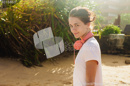 Image of Woman walking on the beach