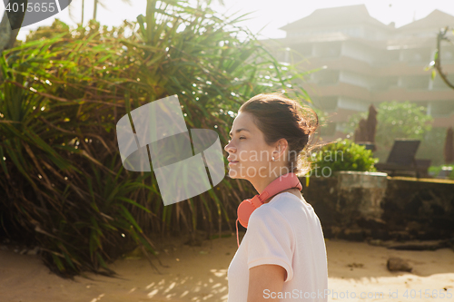 Image of Woman walking on the beach