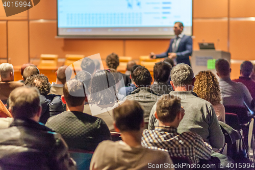 Image of Business speaker giving a talk in conference hall.