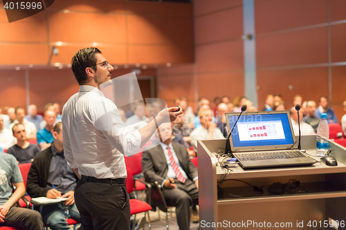 Image of Public speaker giving talk at Business Event.