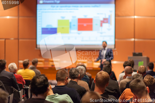 Image of Business speaker giving a talk in conference hall.