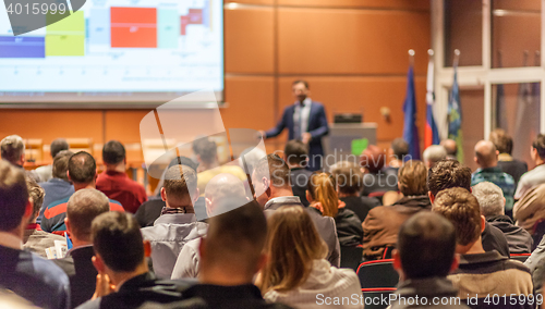 Image of Business speaker giving a talk in conference hall.