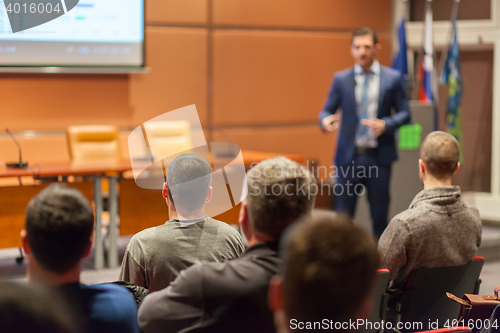 Image of Business speaker giving a talk in conference hall.