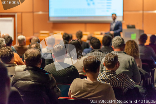 Image of Business speaker giving a talk in conference hall.